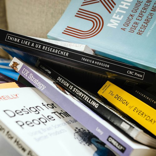 Design books scattered on a table show their titles