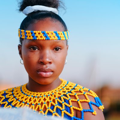 African woman wearing a beads necklace and a beads headband